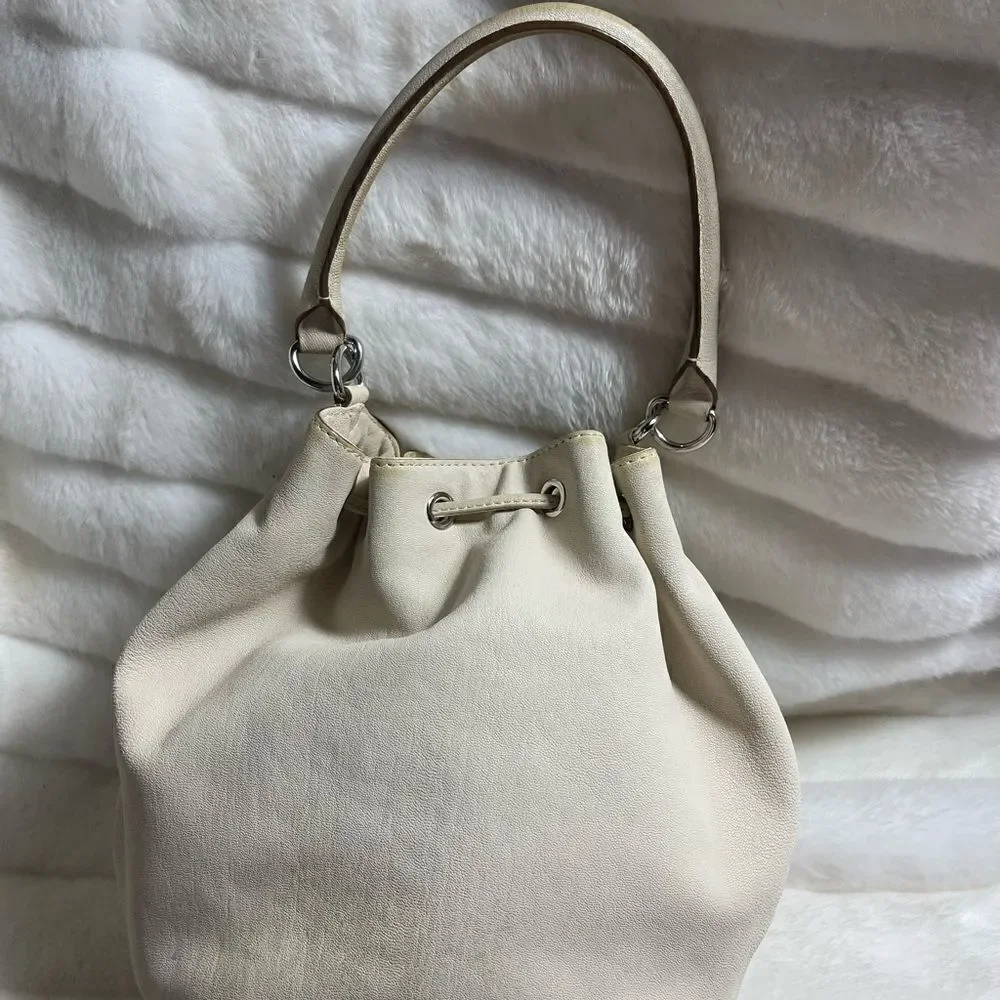 Michael Michael Kors leather beige drawstring bucket satchel.silver tone accents